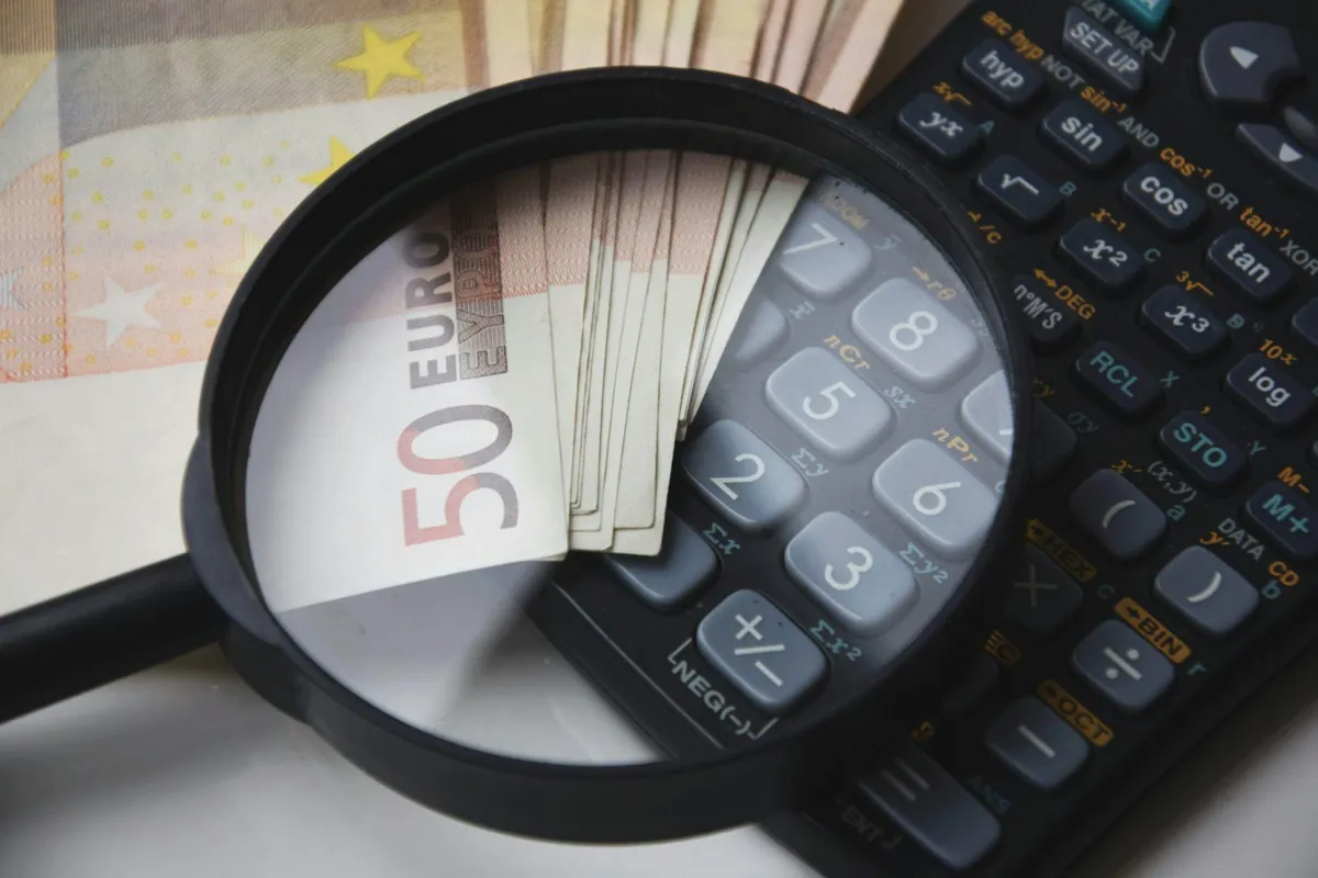 Single audit services for nonprofits — magnifying glass over financial calculator and currency